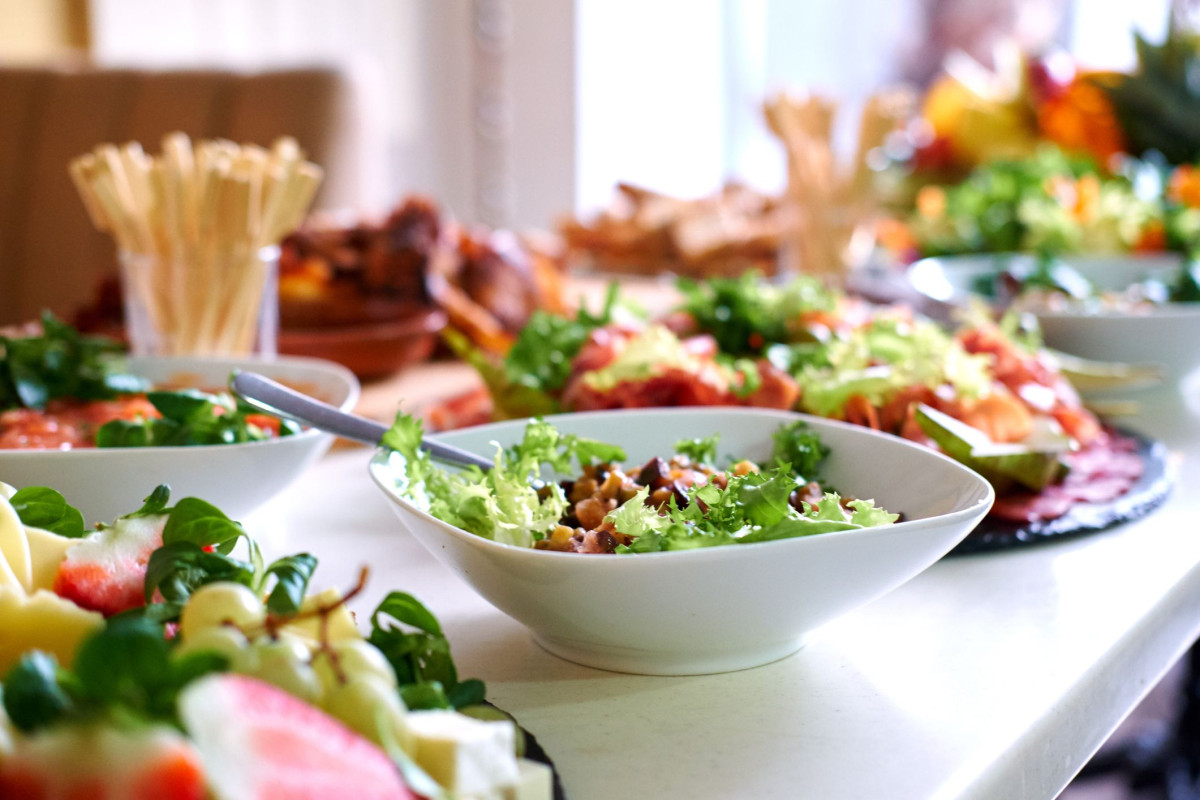 Salads and snacks on a table royalty free image 1576744369